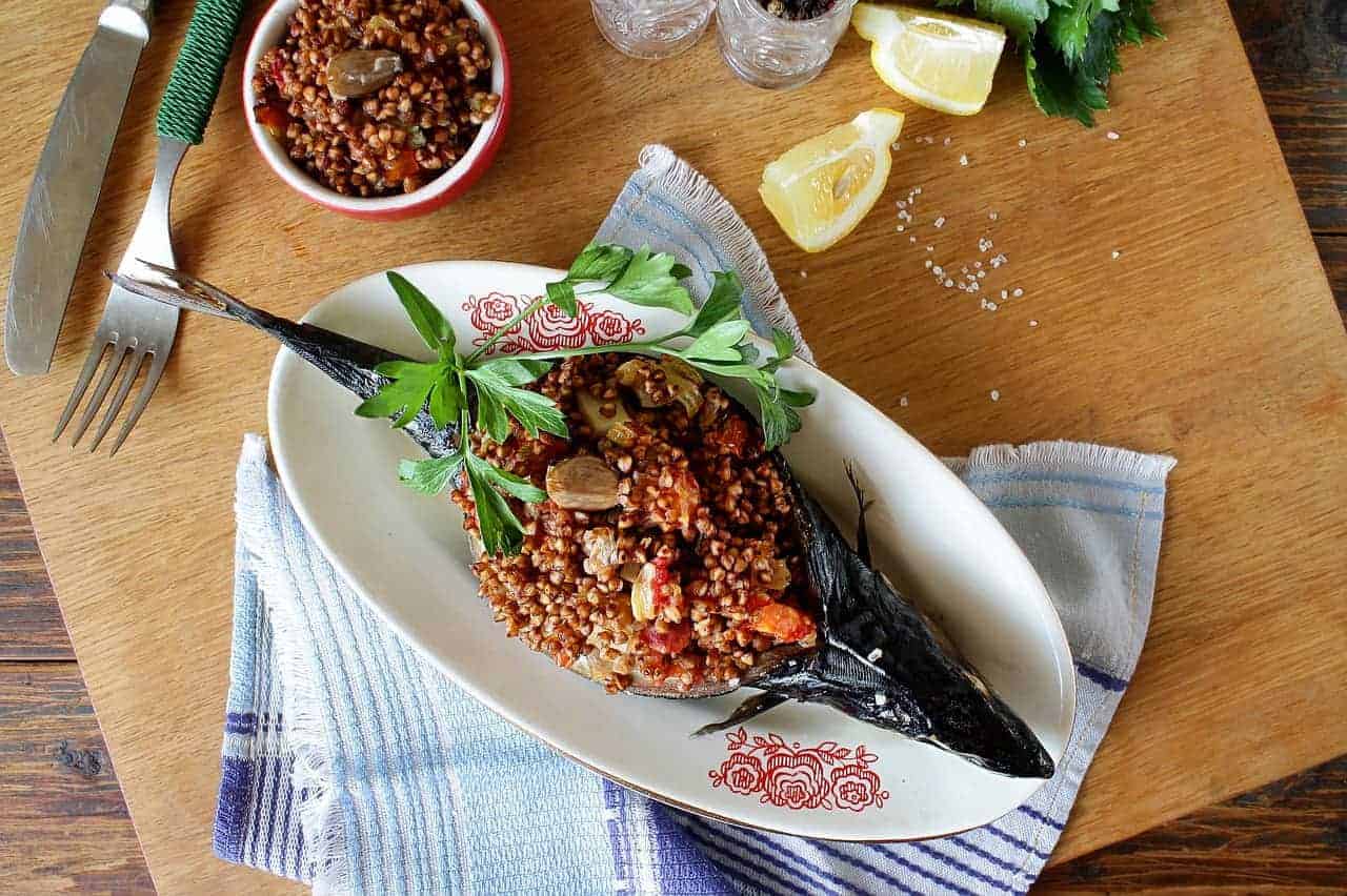 A baked mackerel filled with meat, grain and veggie stuffing.